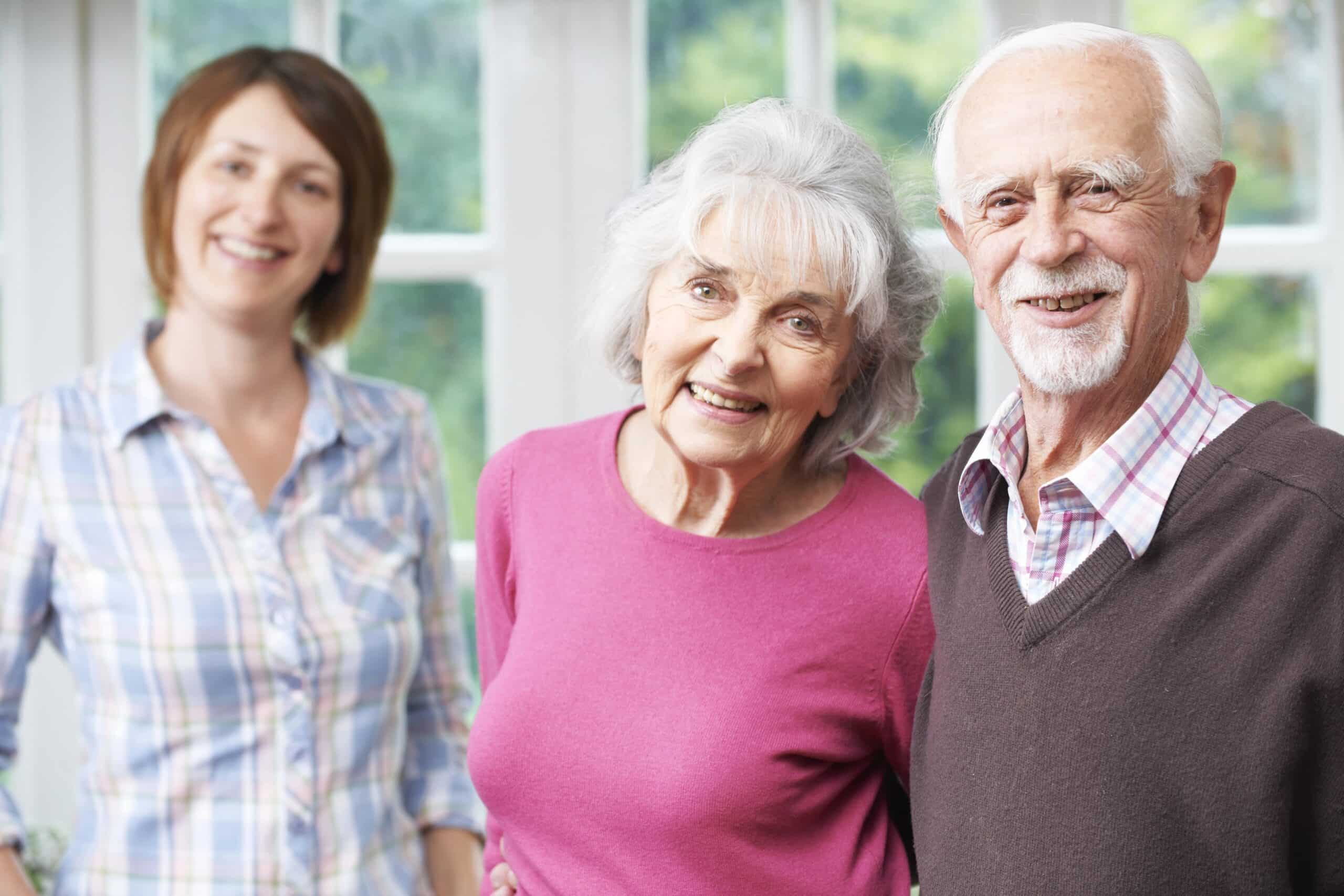 Senior couple smiling for camera with daughter